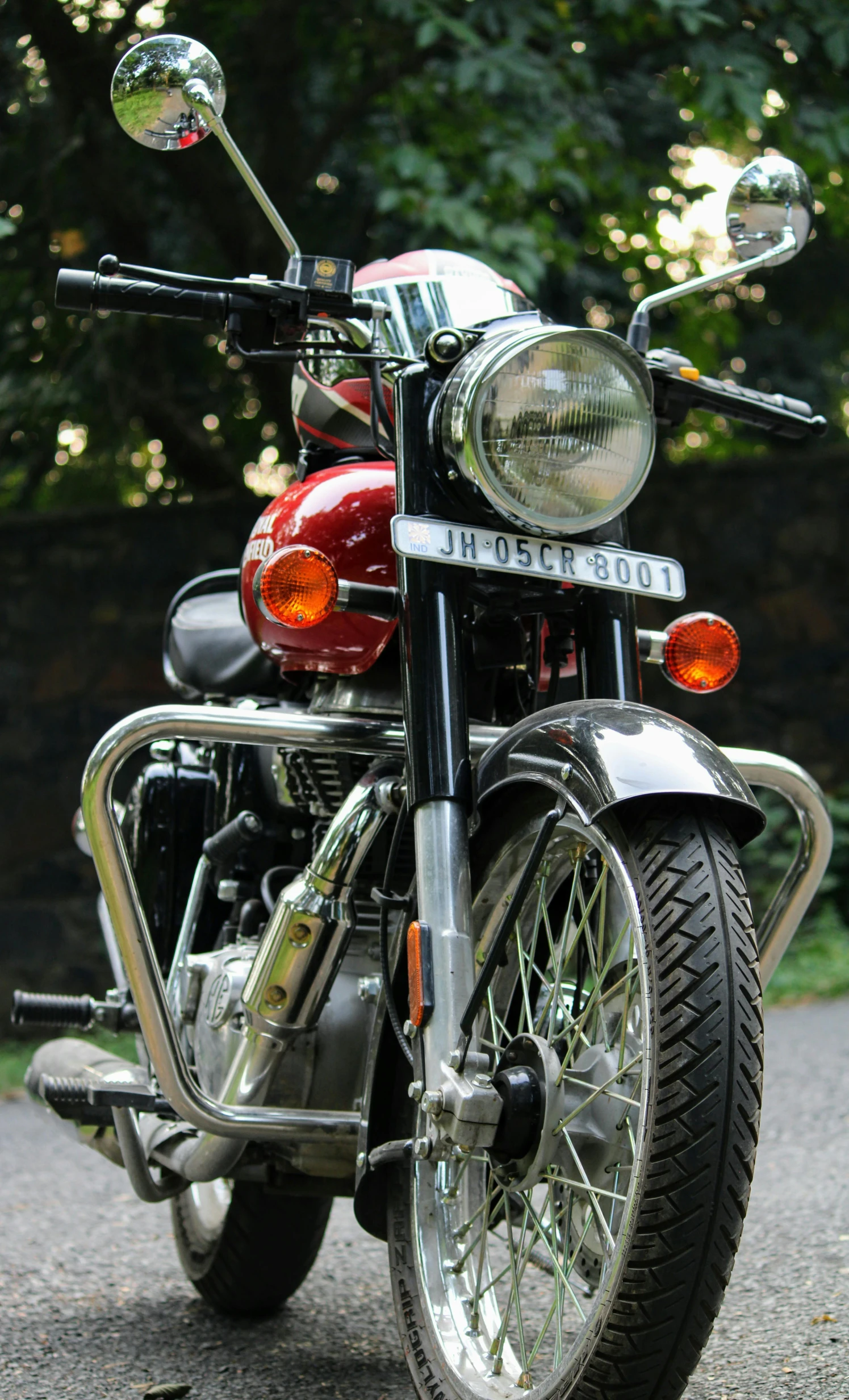 a red motorcycle parked on a paved path