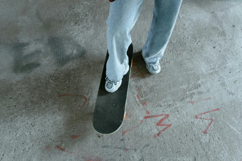 a person is standing on their skateboard in the cement
