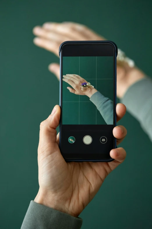 a woman taking a po with her cell phone