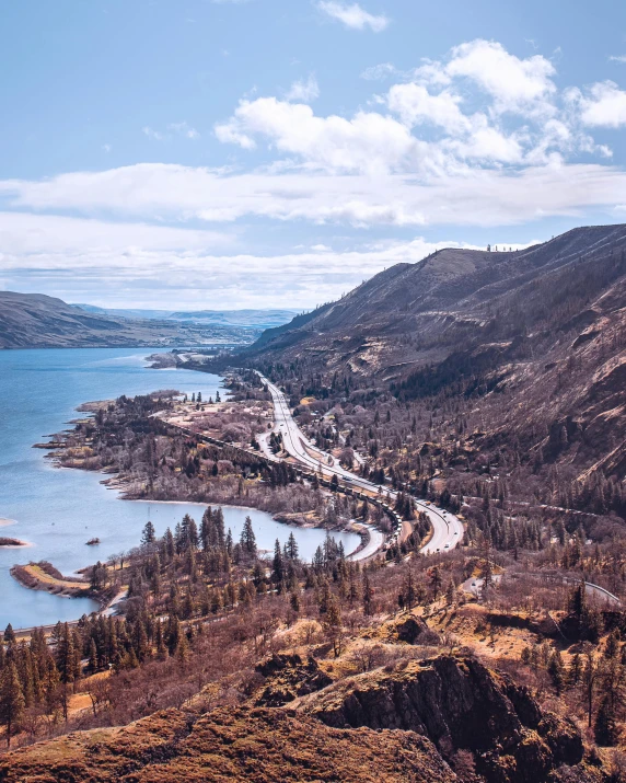 a scenic area with lake in the middle and mountains to the left