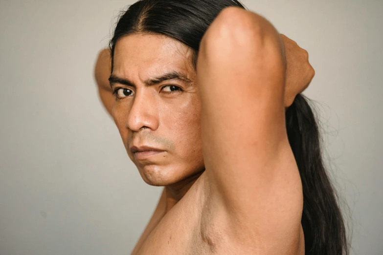a man in a ponytail and  posing for a picture