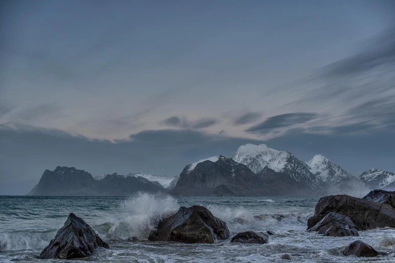 the ocean has waves crashing onto the rocks