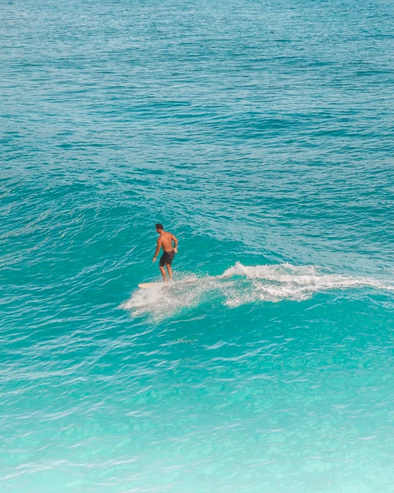 there is a male surfer in the water