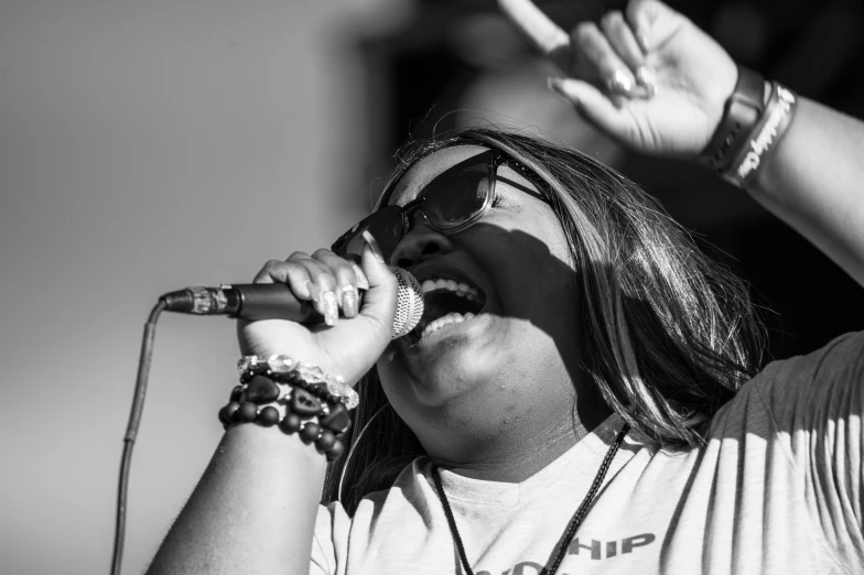 a woman is holding a microphone to her head