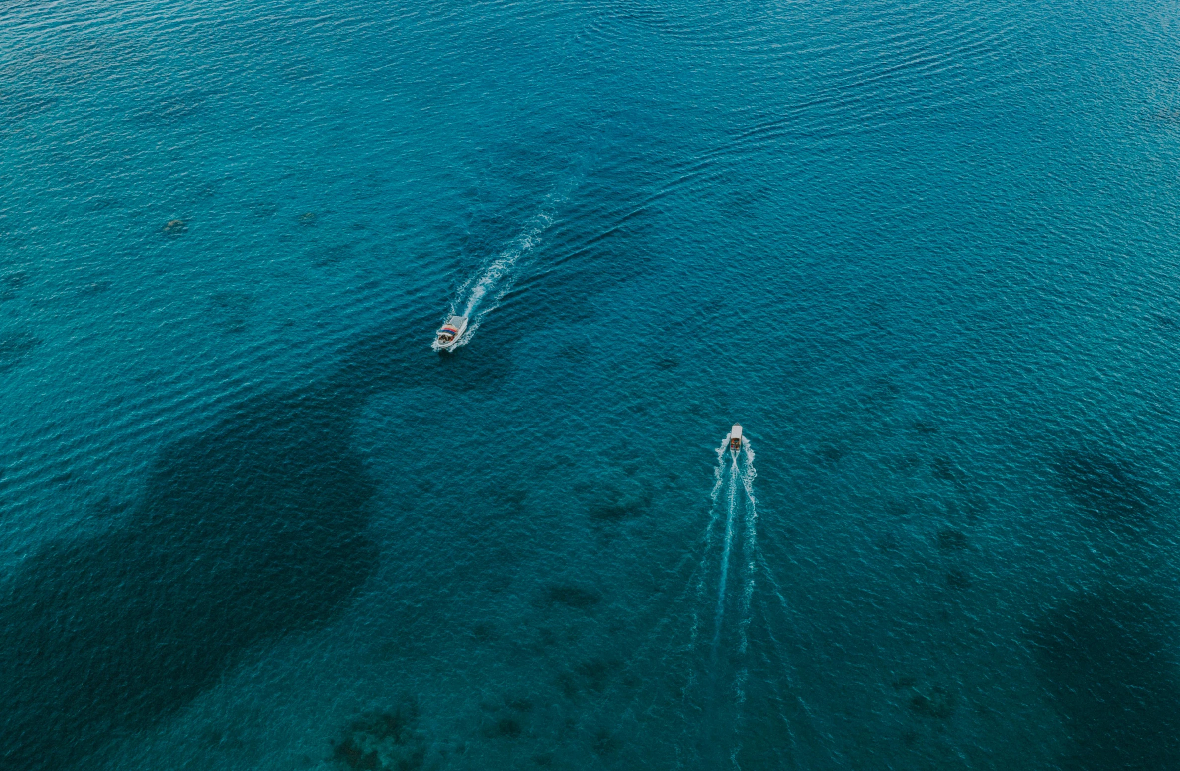 two boats in the blue water of the sea