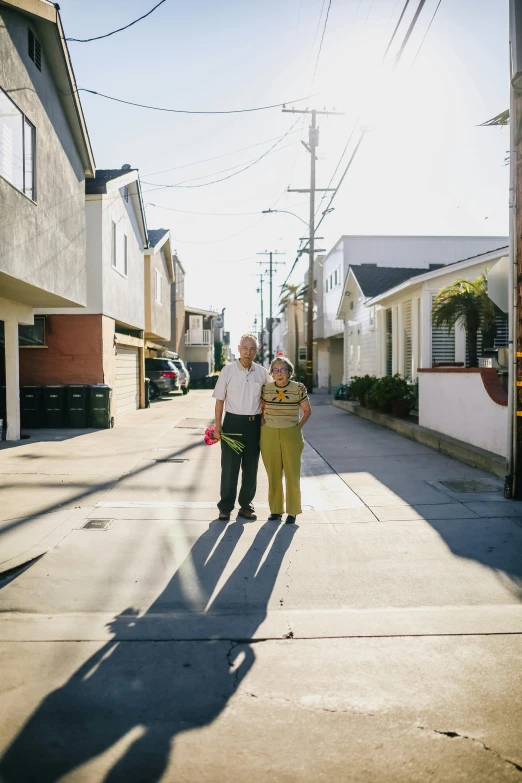 a man standing on the side of a road next to another man