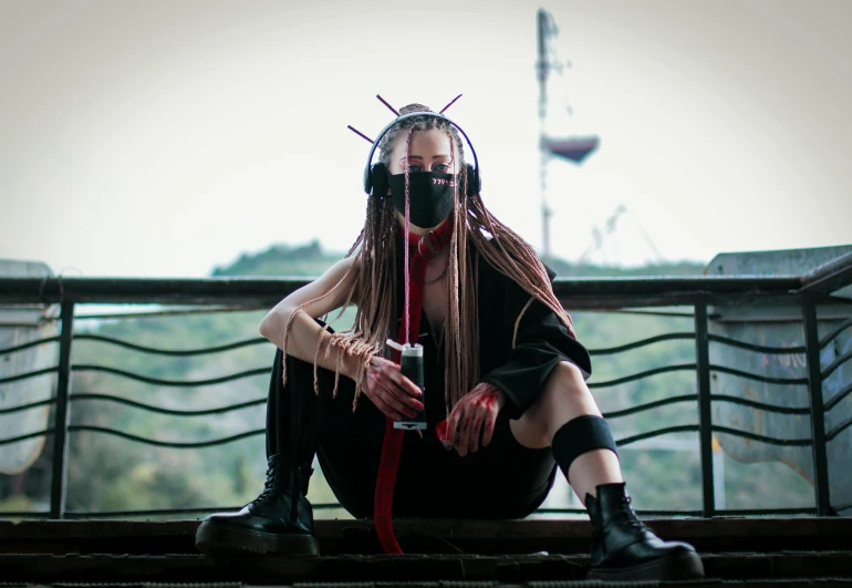 there is a woman with long hair and horned makeup sitting on a bench