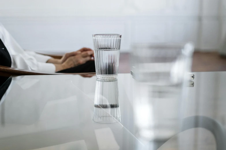 a table that has a glass sitting on it