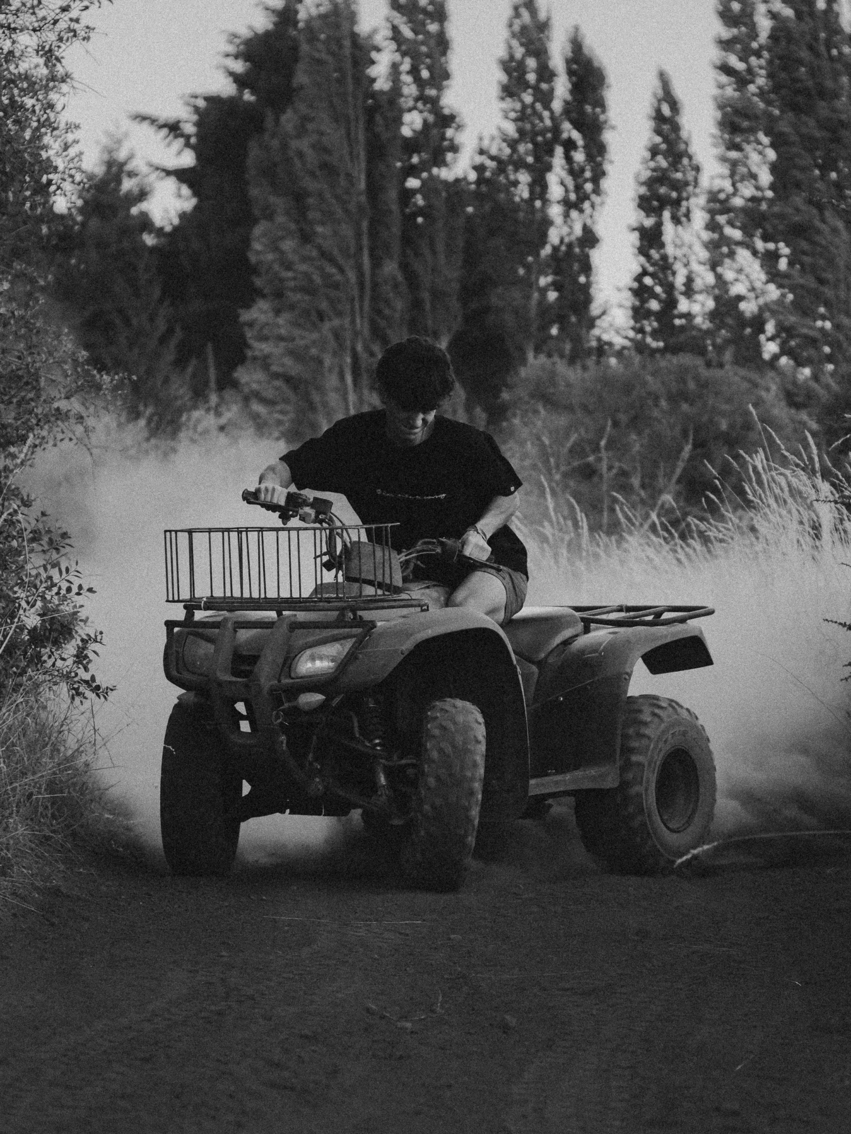 a person on an atv rides through the dirt