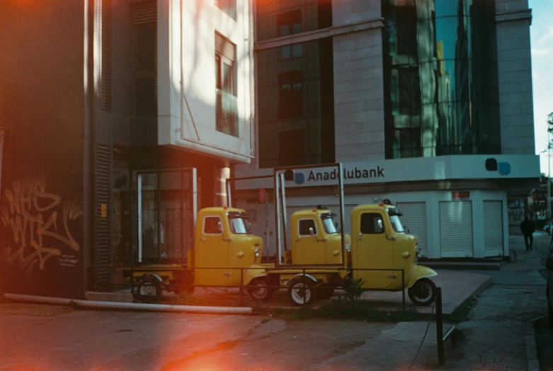 two yellow trucks are parked side by side