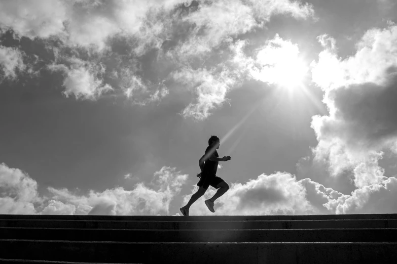 a person is running over a set of stairs in the sunlight