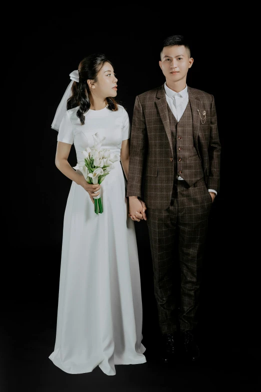 an image of a man and woman in wedding outfits