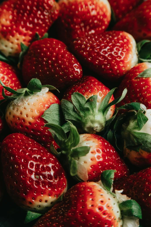 a pile of strawberries that are sitting together