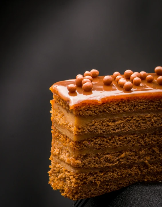 a layer cake with brown decorations and nuts