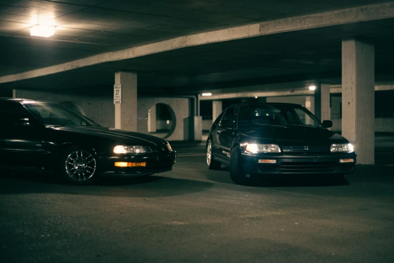 two cars sitting in the middle of a parking lot