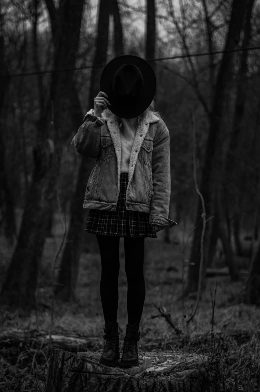 black and white po of girl walking through the woods