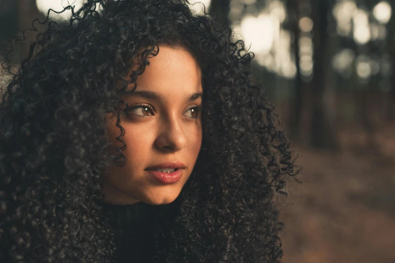 a close up of a person with curly hair