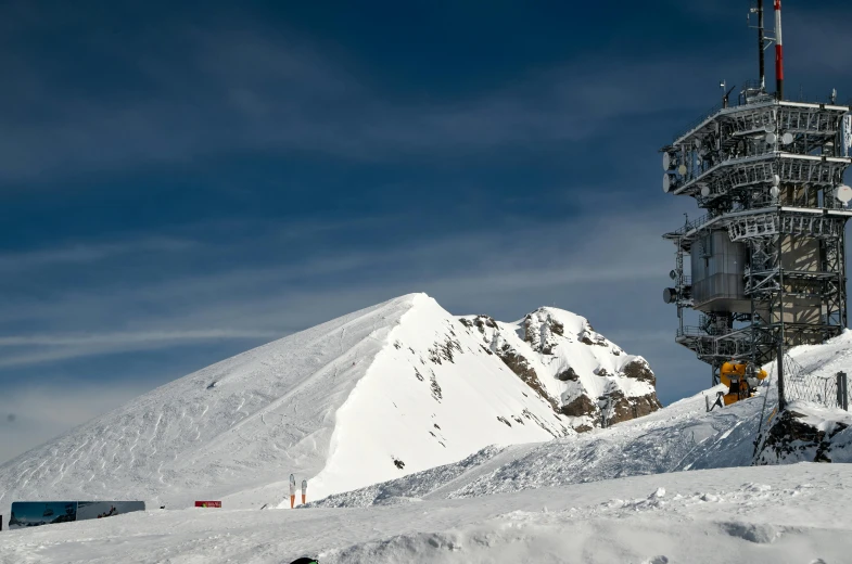 skiers going down the side of a snow covered mountain