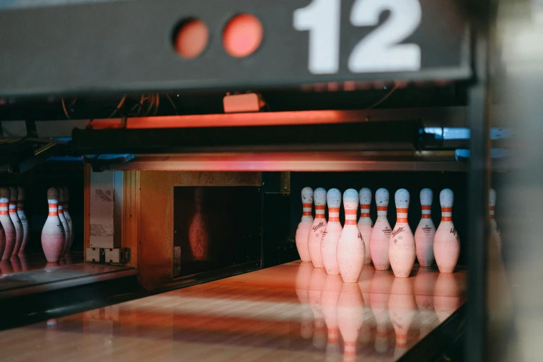 an image of several bowling pins going in to the alley