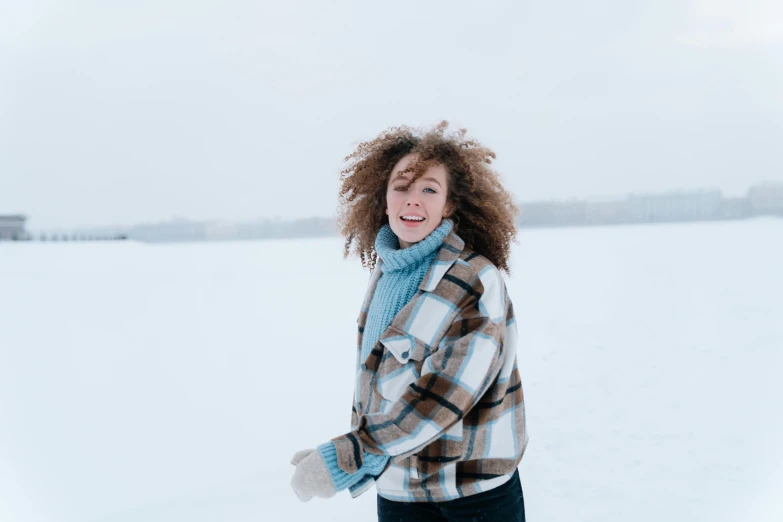 there is a woman with curly hair in the snow