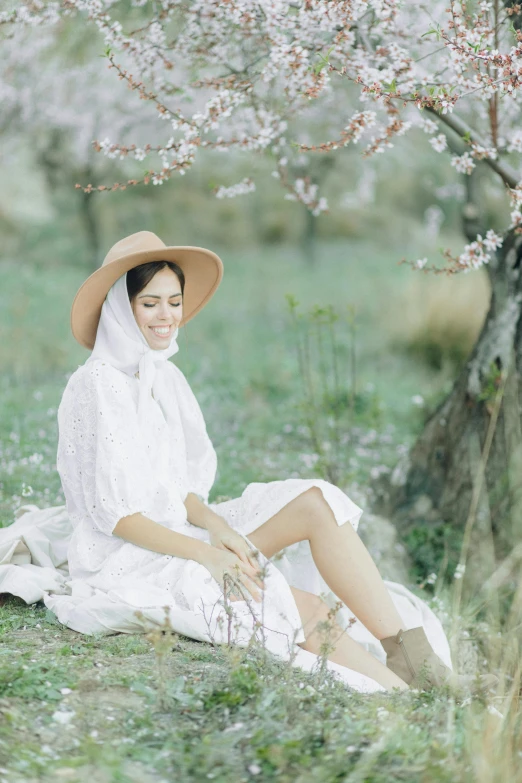 woman wearing a hat in a field of flowers