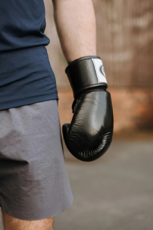 an older person wears boxing gloves while standing