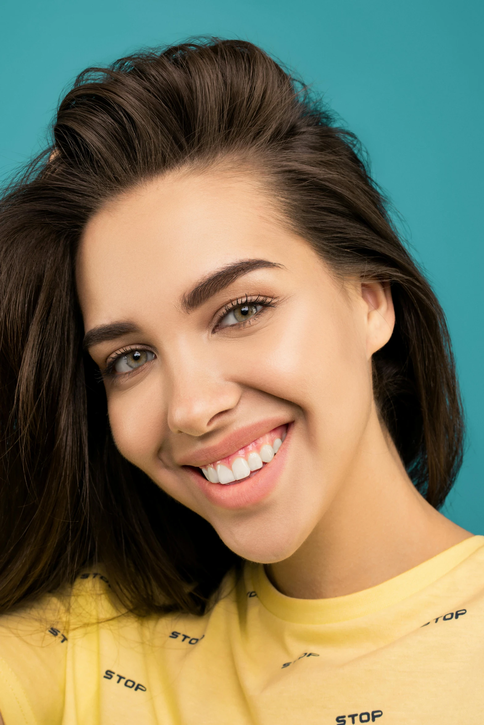 a woman in yellow smiling at the camera