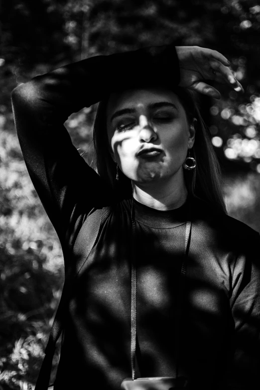 a young man blowing a cigarette in the park