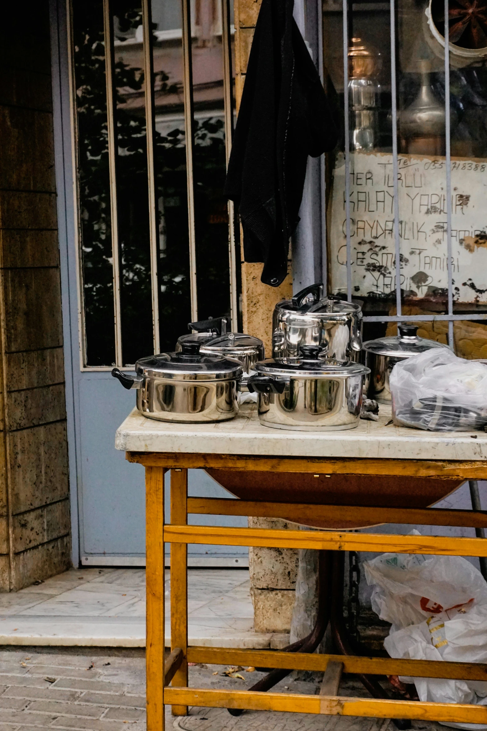 pots are sitting outside on a table