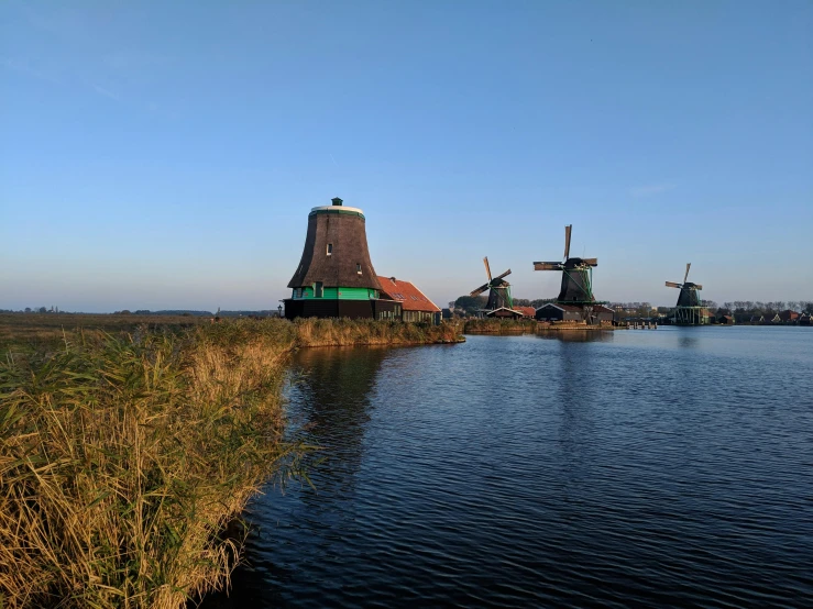several windmills with a large body of water