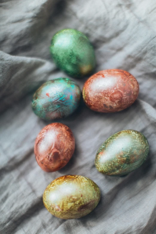 four metallic egg halves are on a gray background