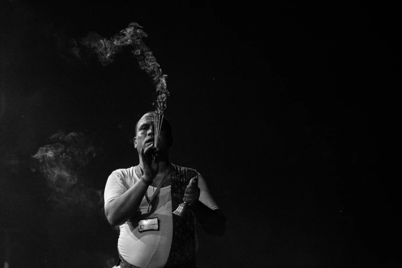 a man smoking in a dark room