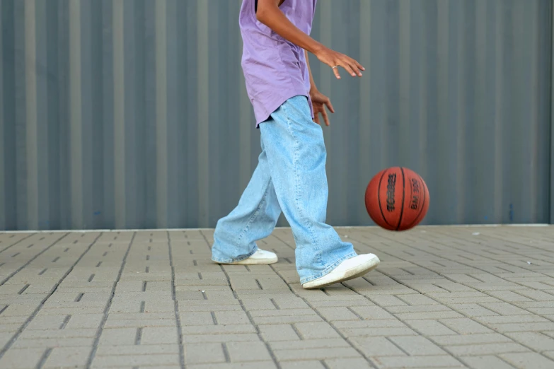 a young man is spinning a basketball on his finger