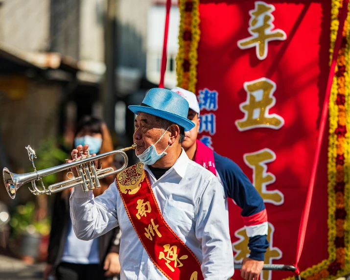 some people are marching through a street with musical instruments