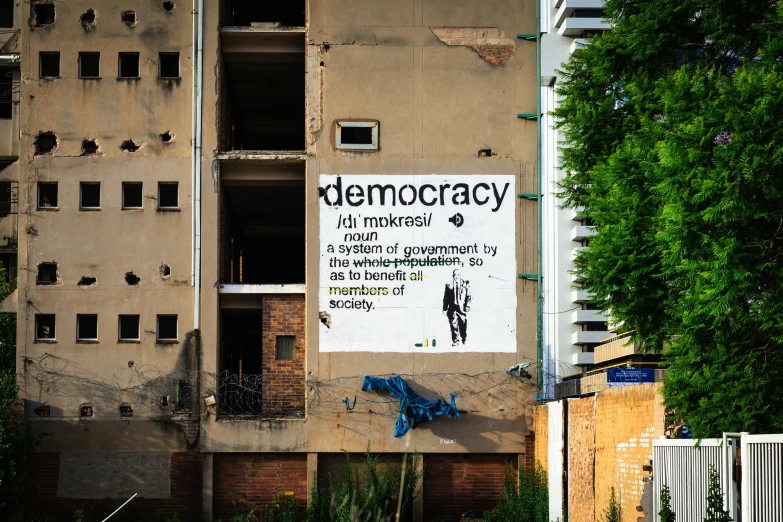 a sign on an old building that says democracy