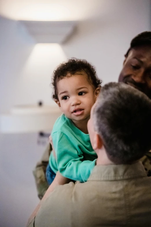 a man holding a small child in his arms