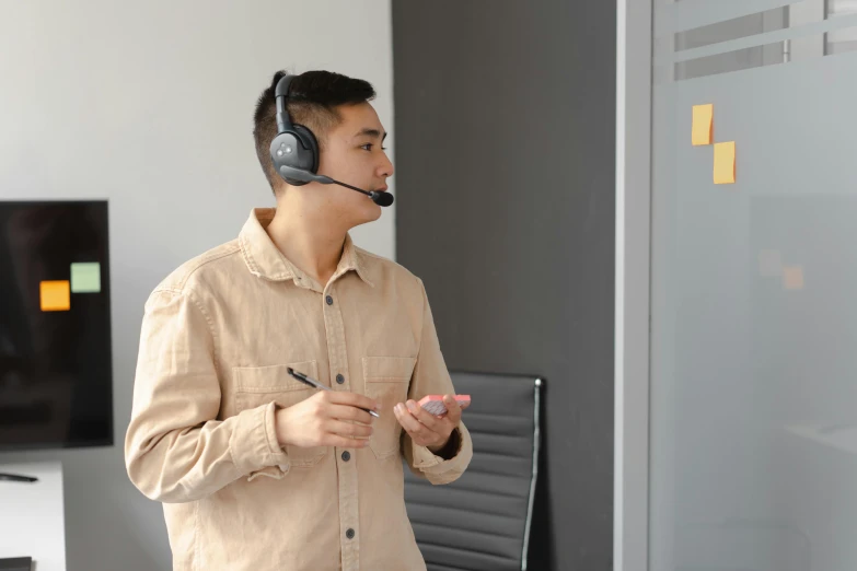 the man is wearing a headset and listening to music