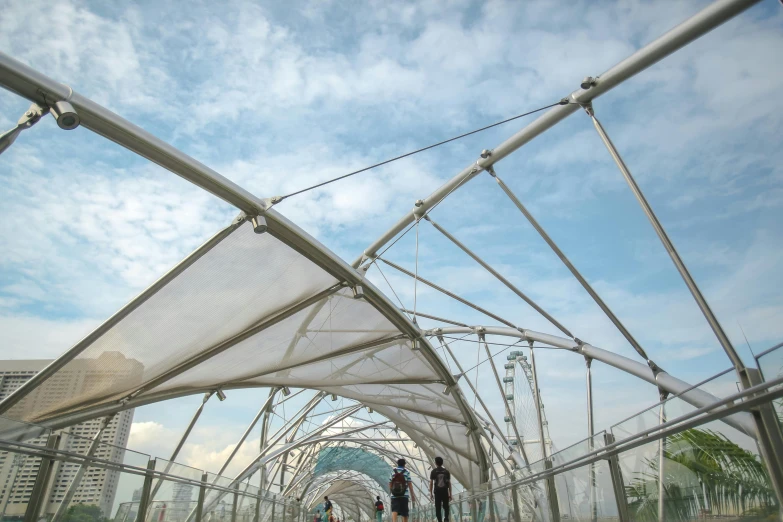 a person walking on a walkway beneath a tent