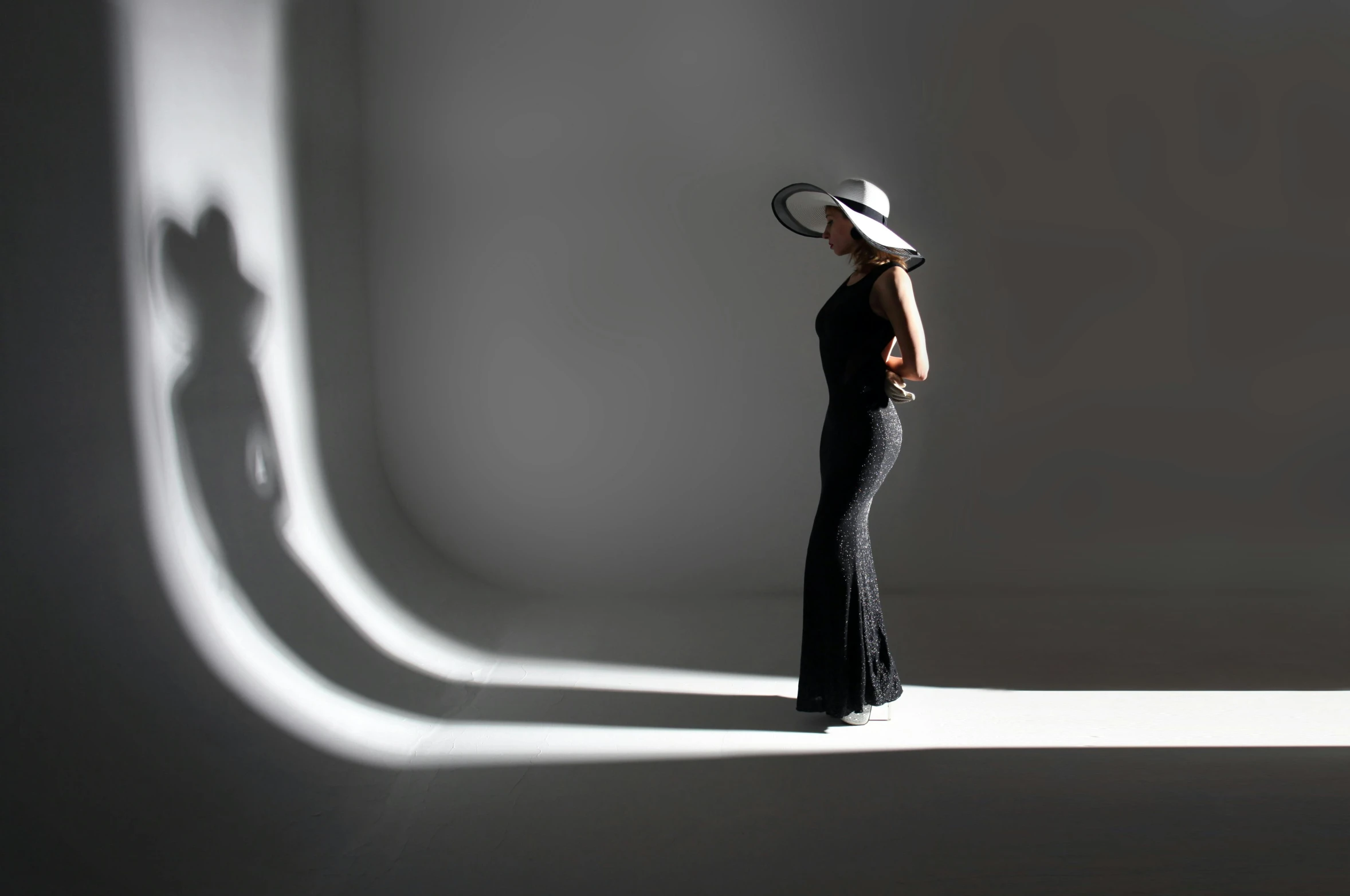 the woman wears a sunhat with a wide brimmed top