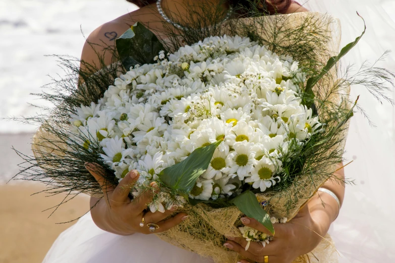 a person holding a bouquet of flowers in their hands