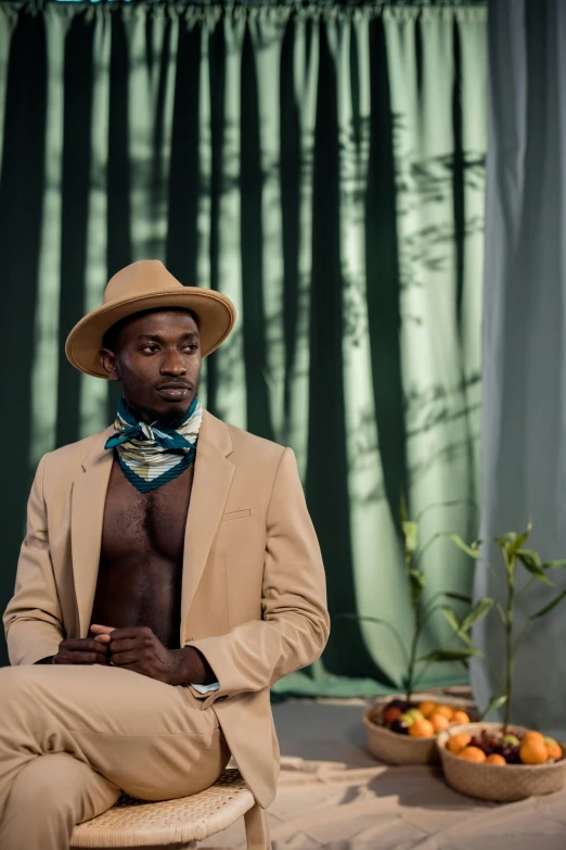 a man sitting in front of a forest filled with fruit