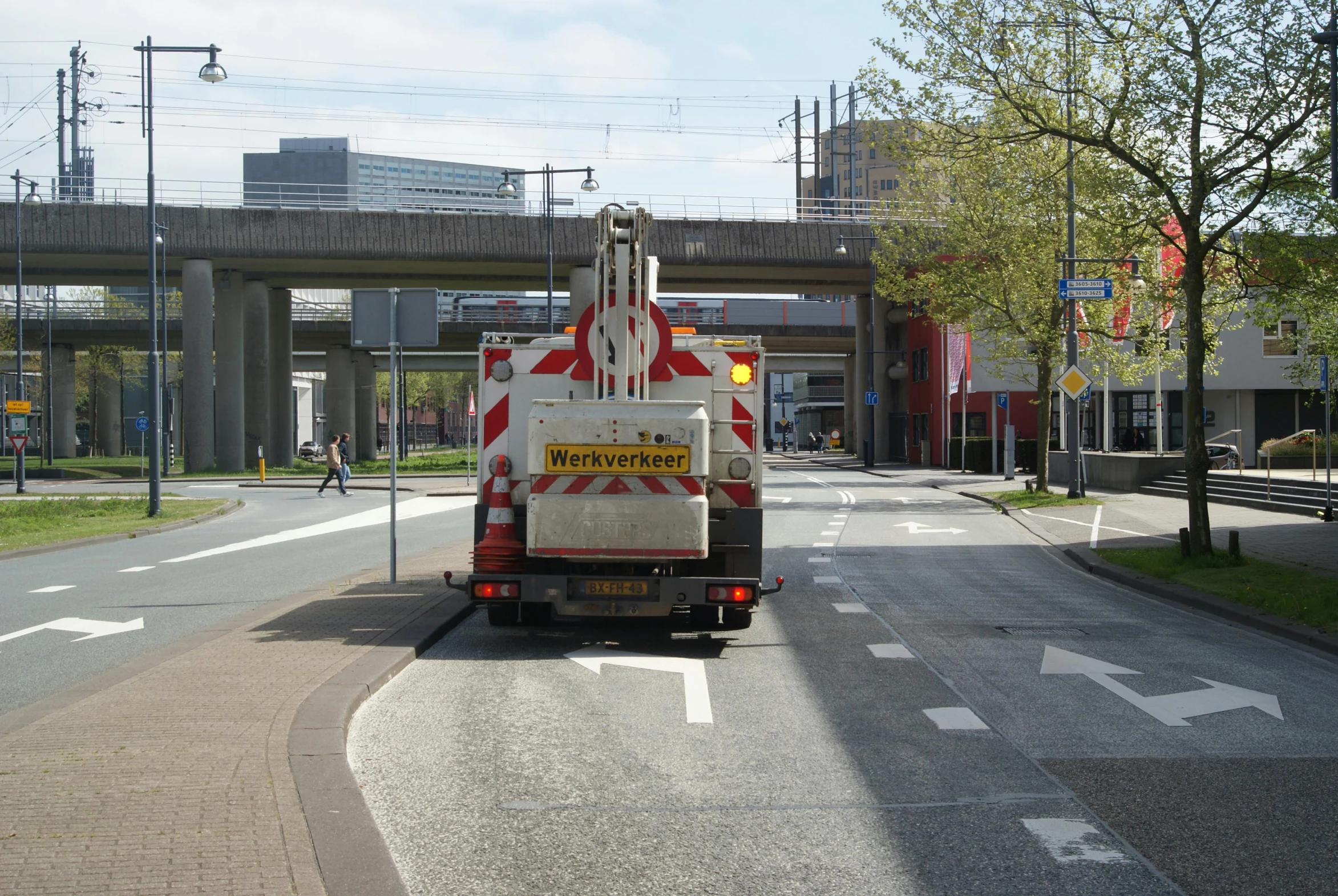 a work truck with safety flags on the side of the road