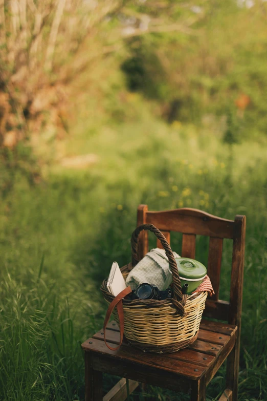 a picnic bench with an open bag on top and a basket on it