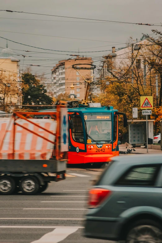 a small truck is driving on the road