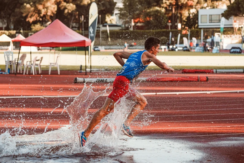 a man running in the rain at a sporting event