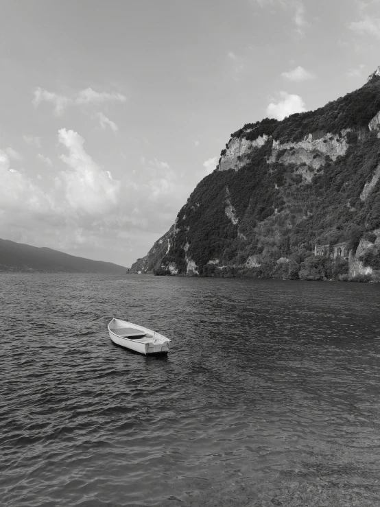 a boat sitting on the edge of a body of water