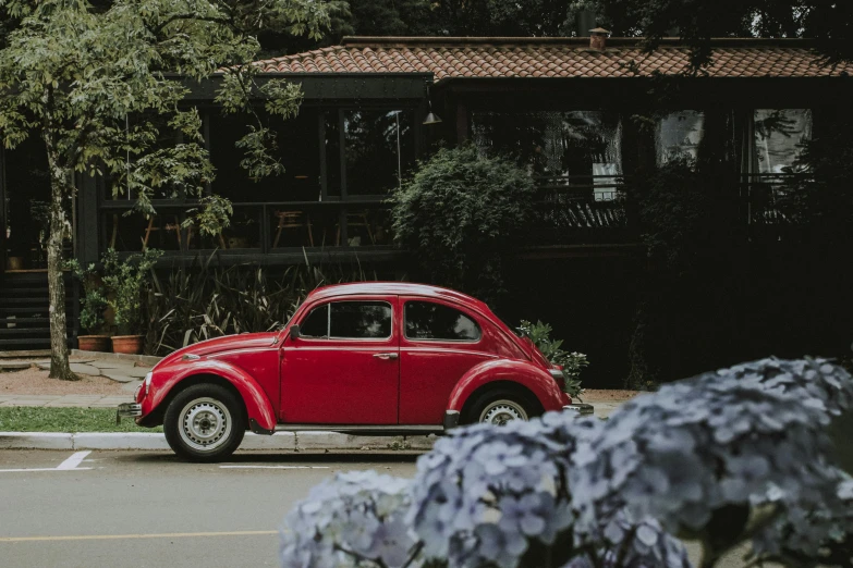 an old car is parked in front of the house