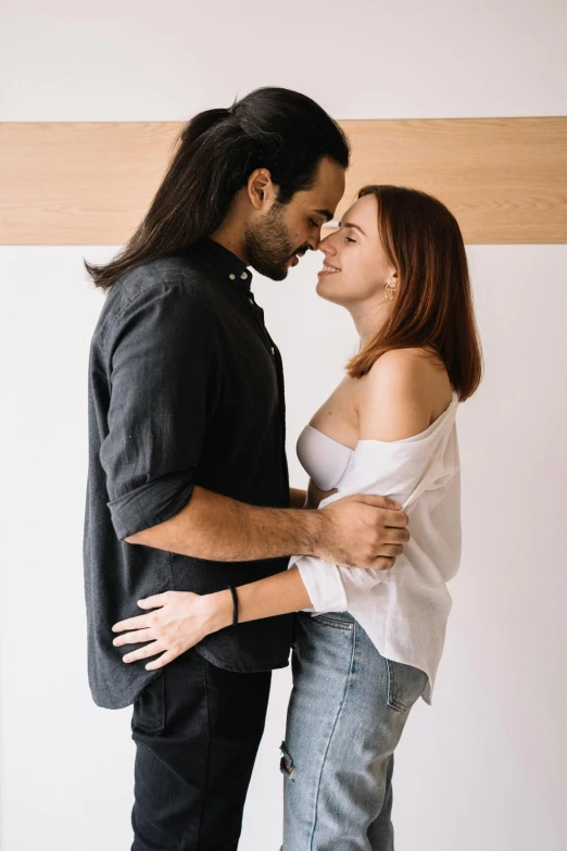 a couple posing for the camera with their arms around each other