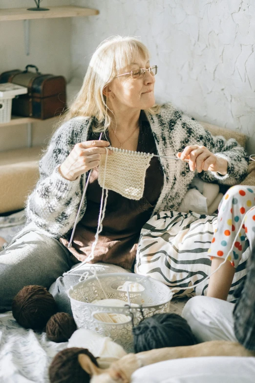 an older woman on a bed with her dog