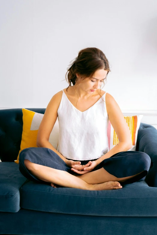 the woman is meditating in the yoga position